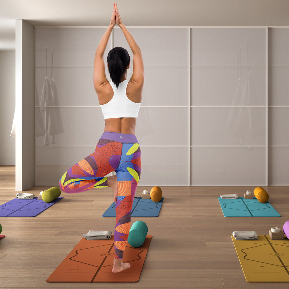 woman in standing yoga pose wearing abstract leaf design leggings