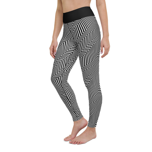 Side view of woman standing in black and white yoga tights